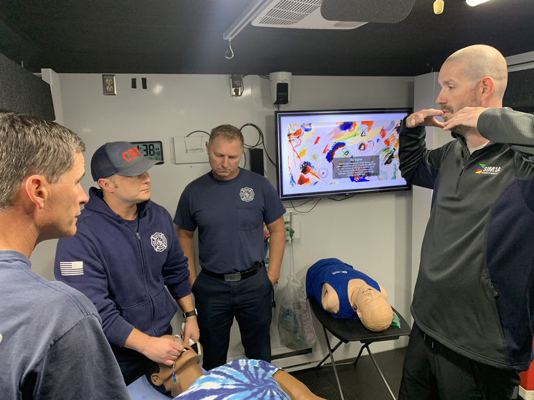 SIM-IA educator with trainees in truck