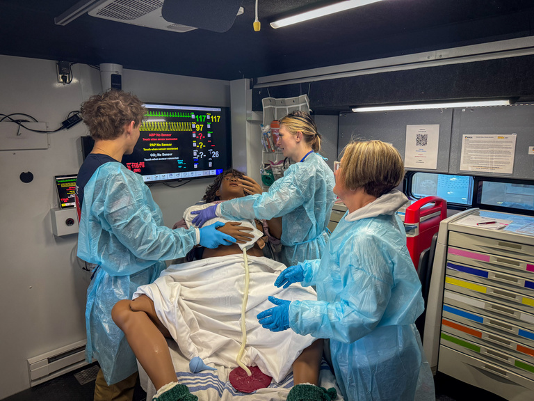 Participants in simulation truck wearing PPE during 2026 Johnson County EMS Saturday