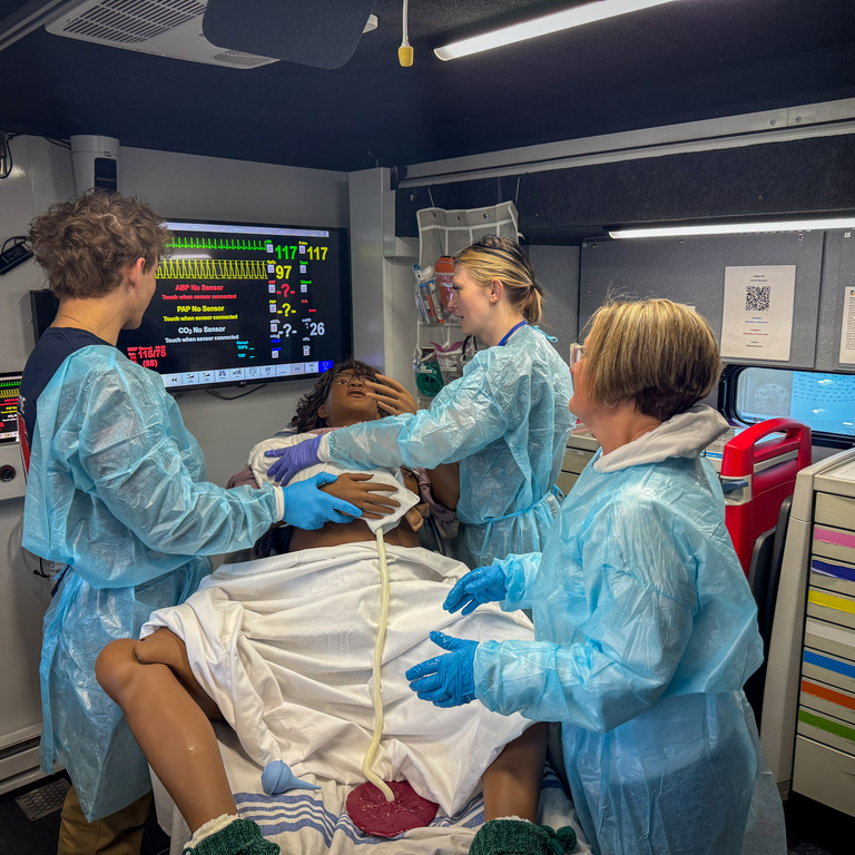 Participants in simulation truck wearing PPE during 2026 Johnson County EMS Saturday