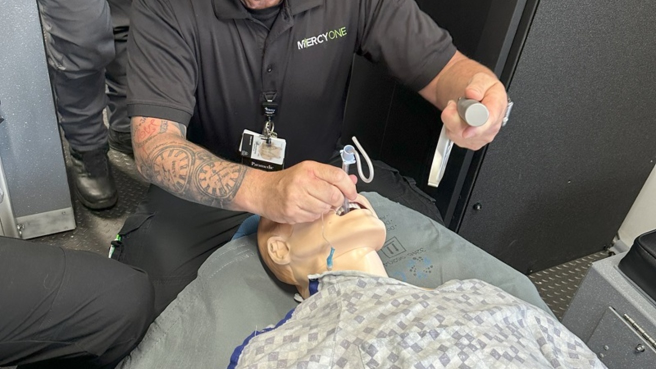 A healthcare professional with a manikin