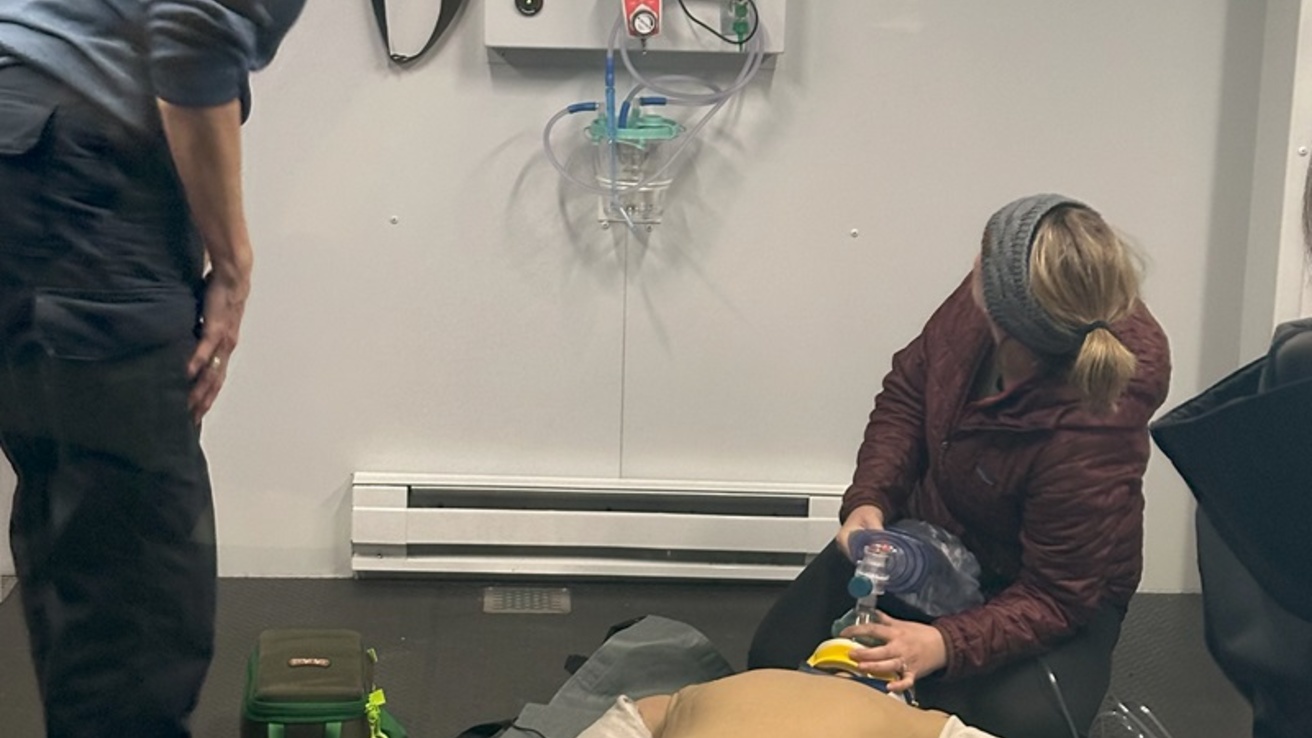 Two healthcare professionals with a manikin