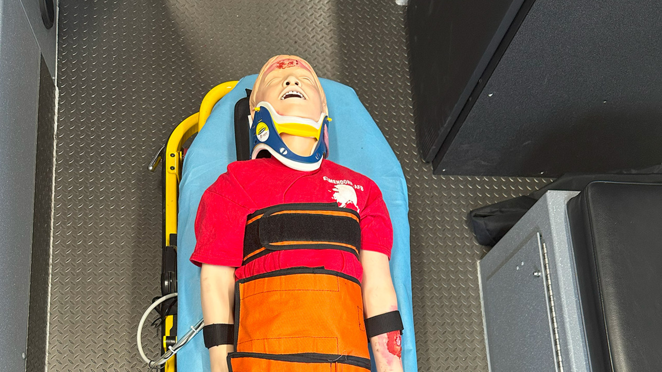 A young adult male manikin on a table, visibly traumatized