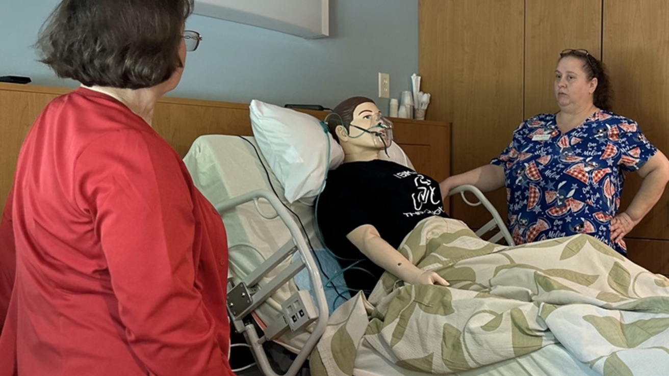 Two healthcare professionals with a manikin